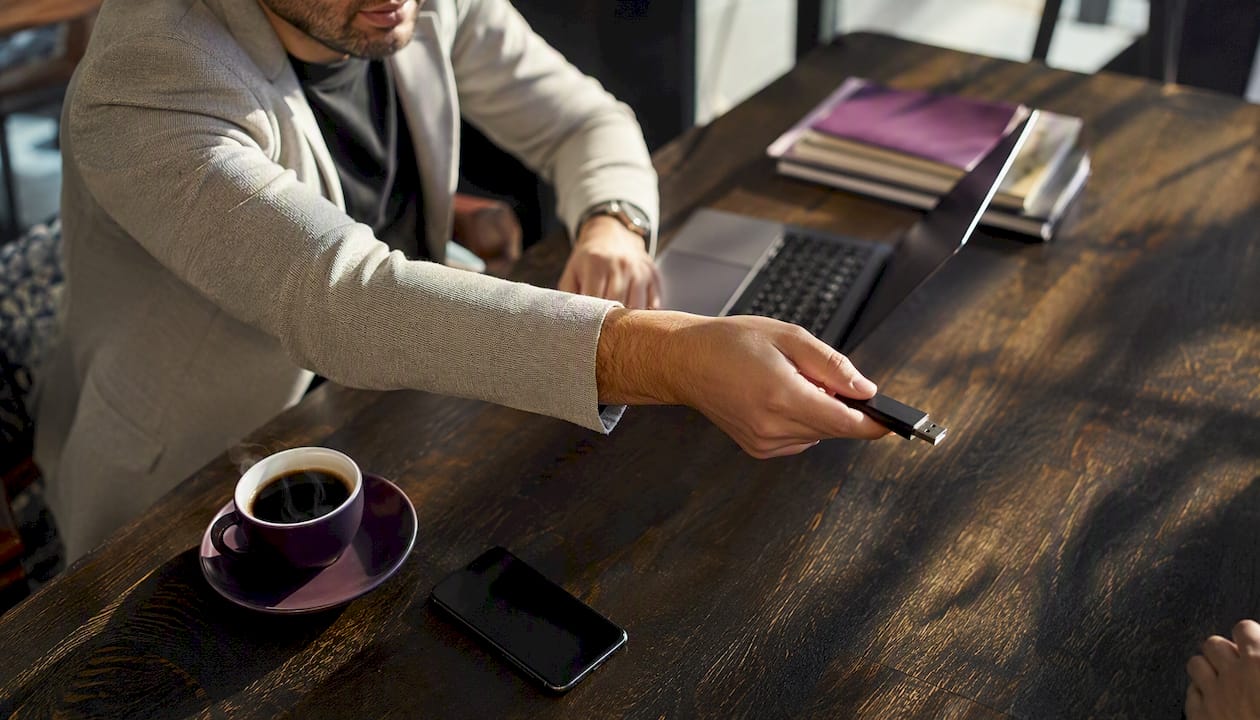 Hands delegating digital work tools