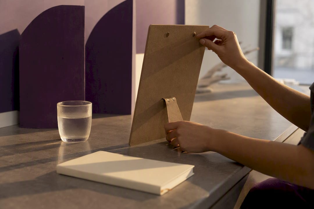 Hand adjusting blank board on desk