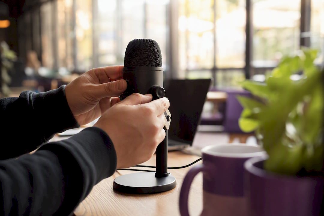 Hands adjusting microphone for speaking test