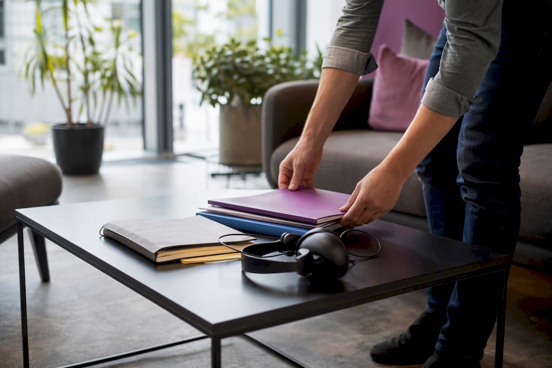 Hands setting aside routine tasks on desk