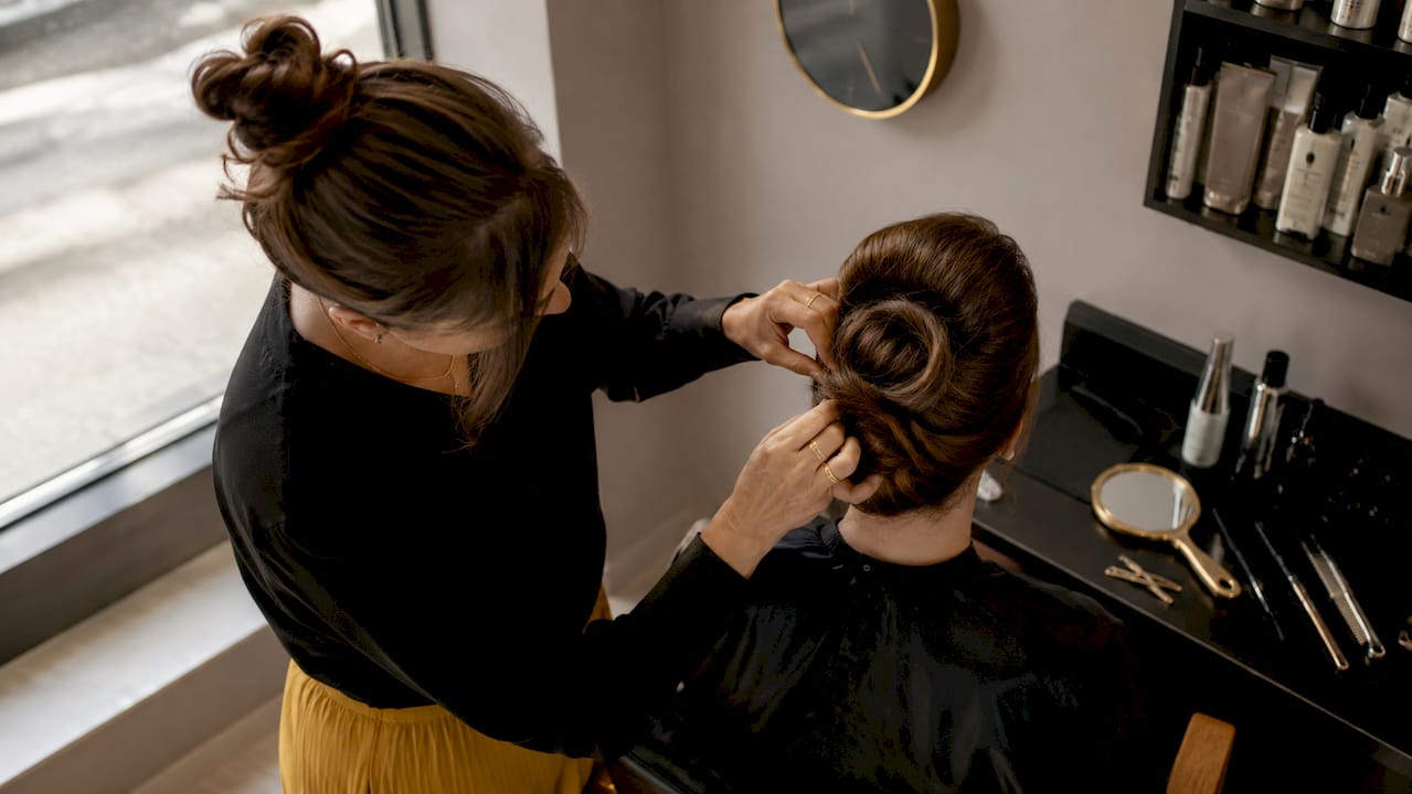 Stylist shaping vintage pin up victory roll hair