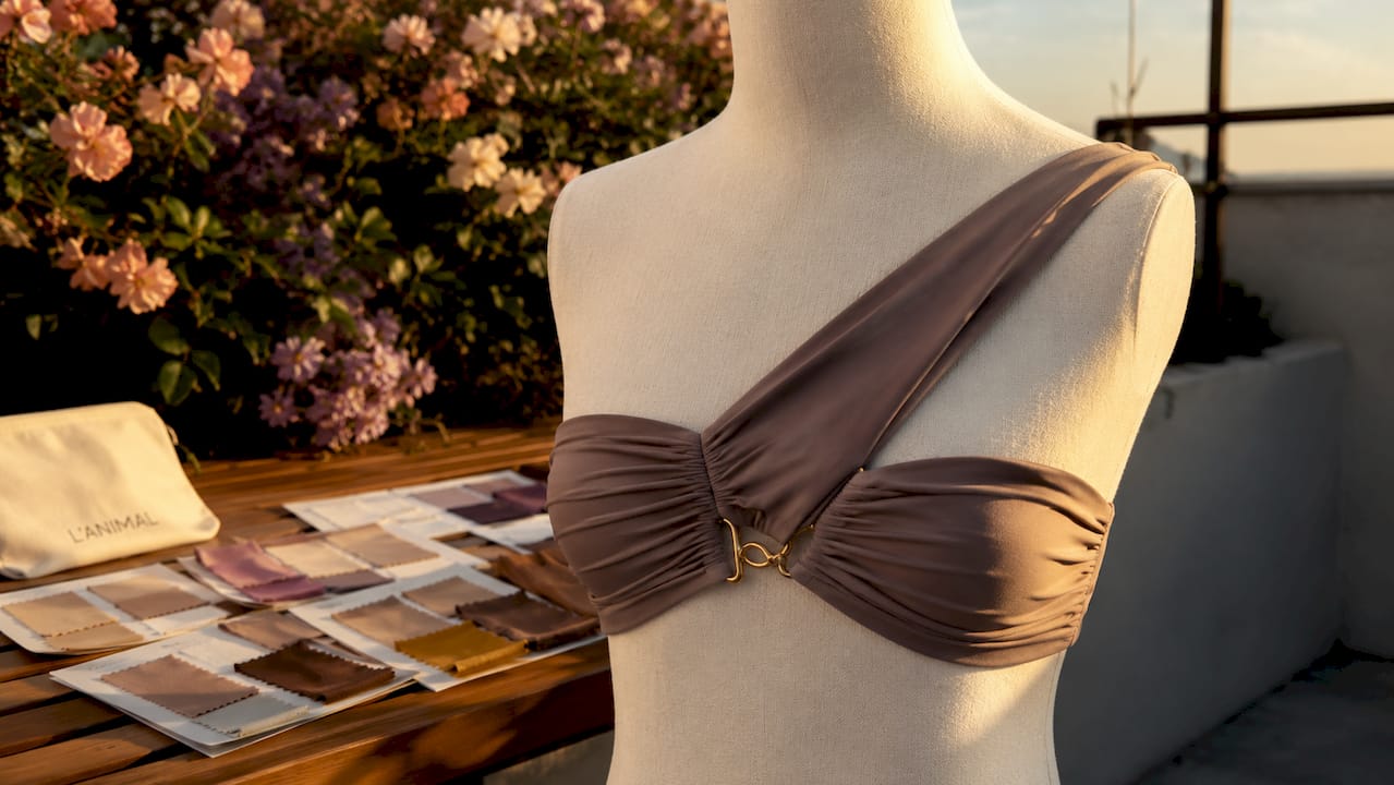 Close-up of ruched asymmetric bikini top on mannequin