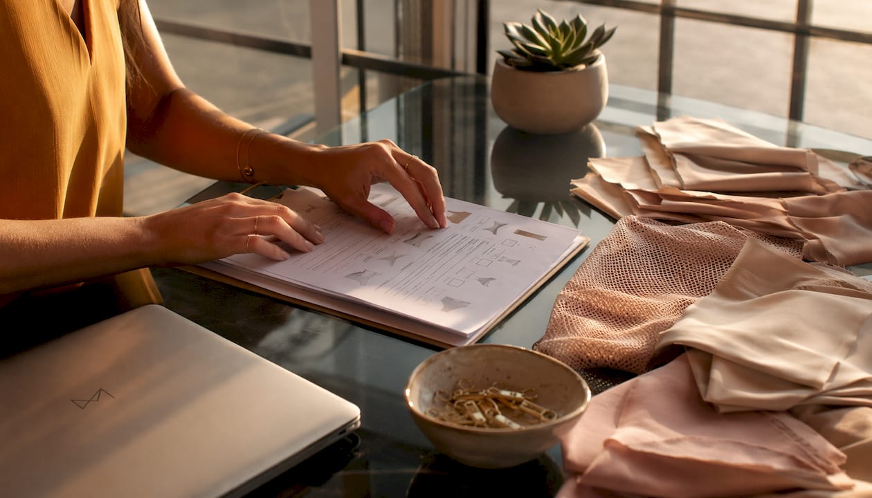 Stylist arranging swimwear checklist at desk