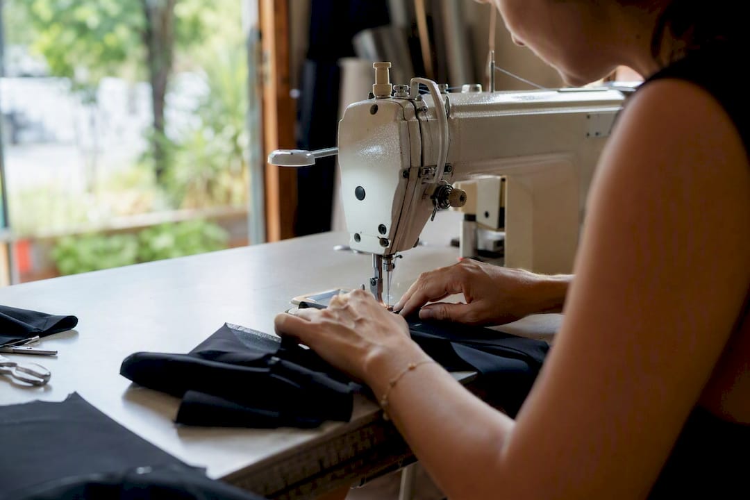 Hands sewing swimwear fabric
