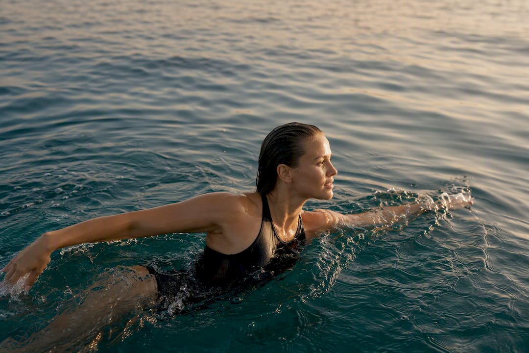 Swimmer in supportive one-piece swimsuit in pool
