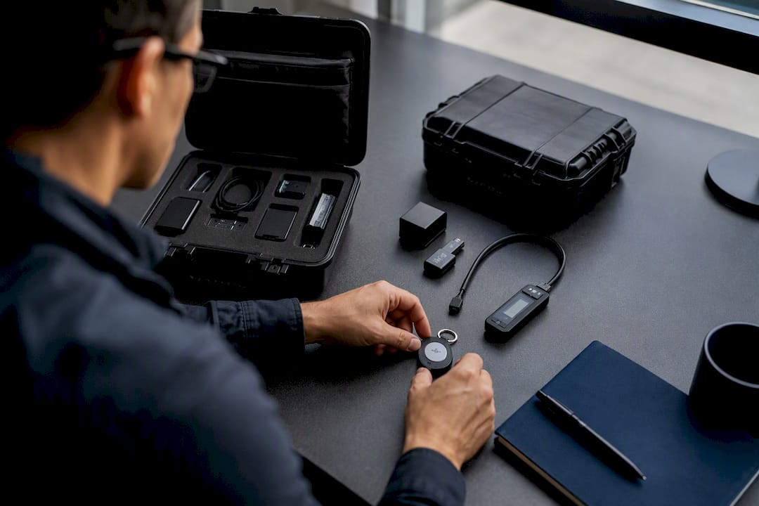 Hands arranging compliance automation device in data center