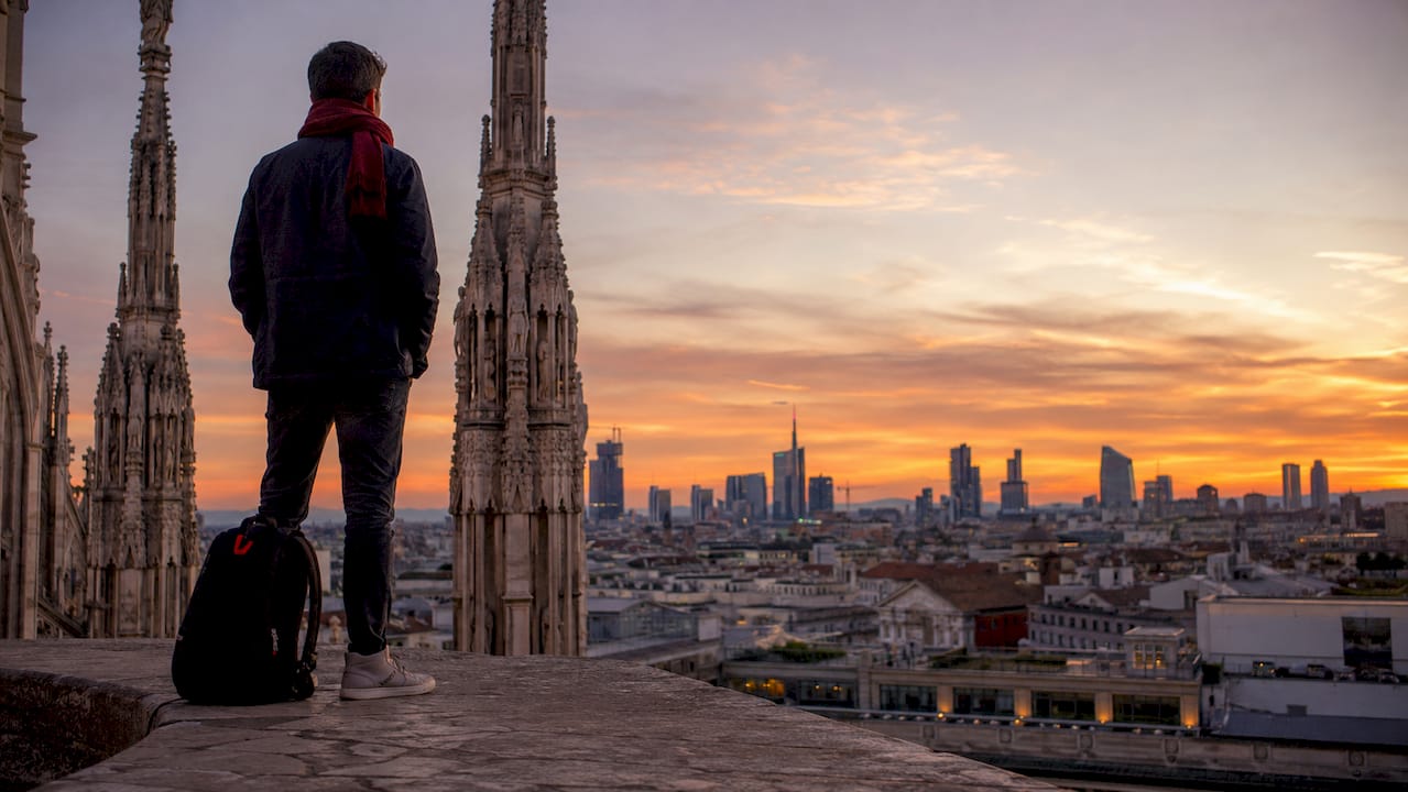 Traveler admiring Milan skyline from Duomo rooftop
