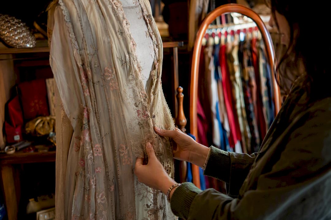 Close-up inspecting vintage coat fabric