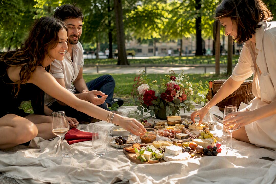 Garden picnic setup with food and drinks in Milan park