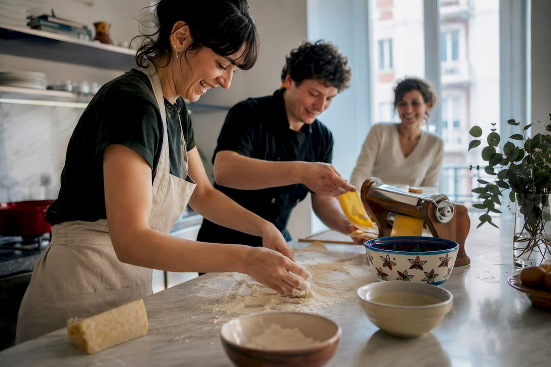 Hands making fresh pasta in Milan apartment kitchen