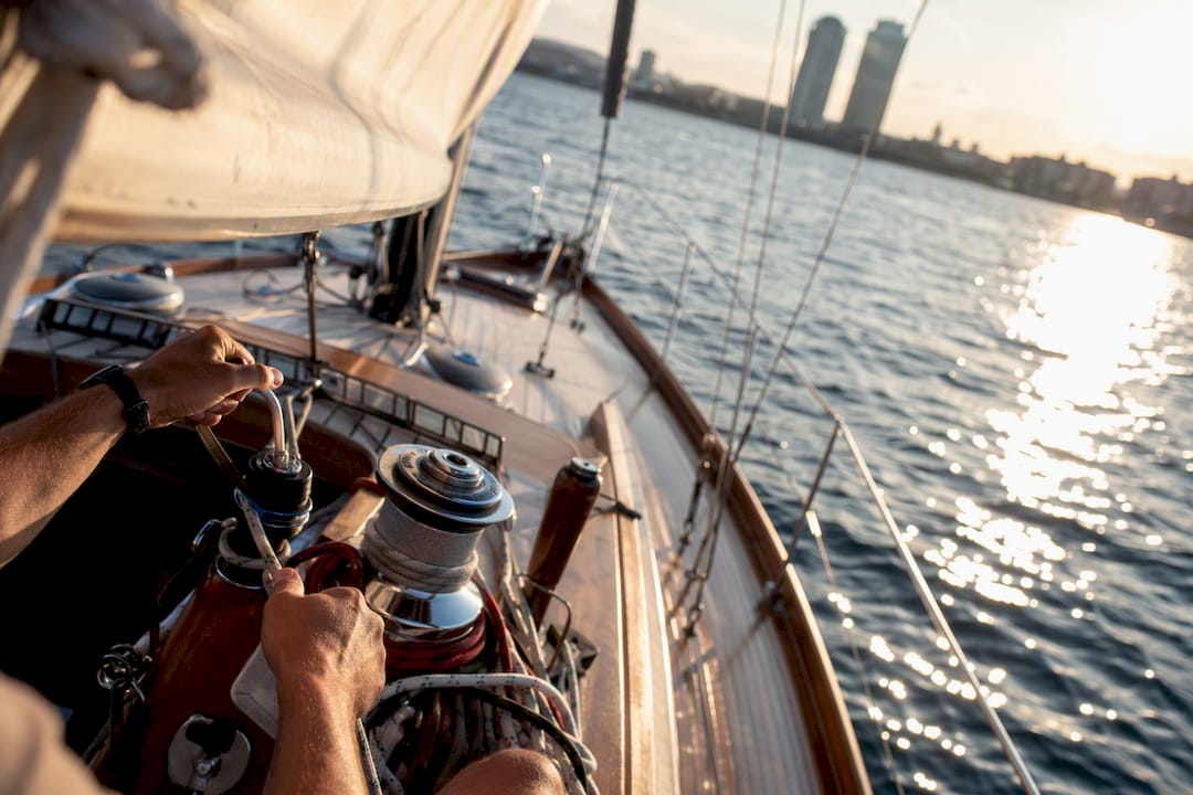 Hands adjusting sails on private boat Barcelona