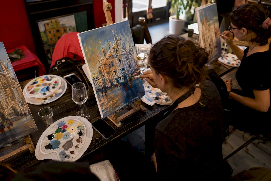 Person painting during paint and sip session