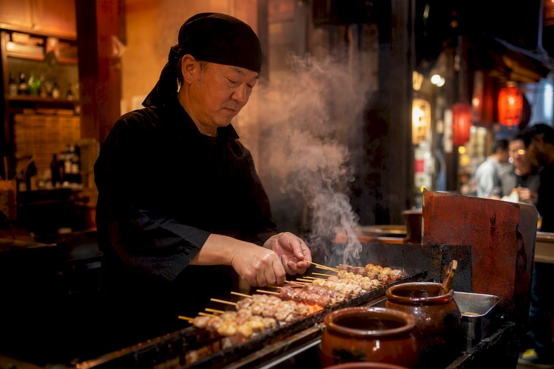 Yakitori skewers grilling over charcoal
