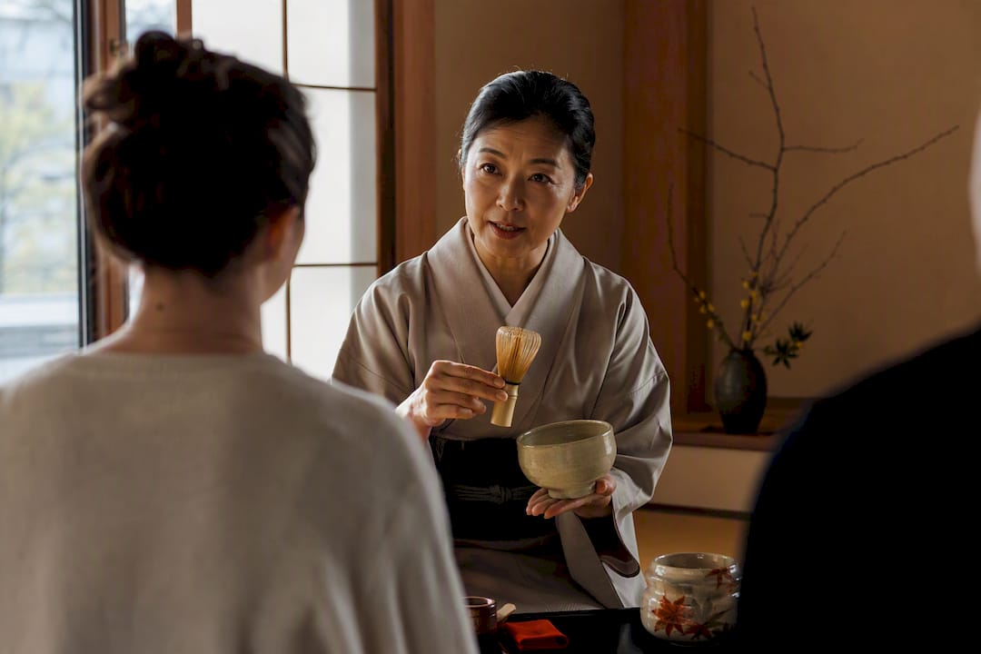Host explaining matcha to workshop guests