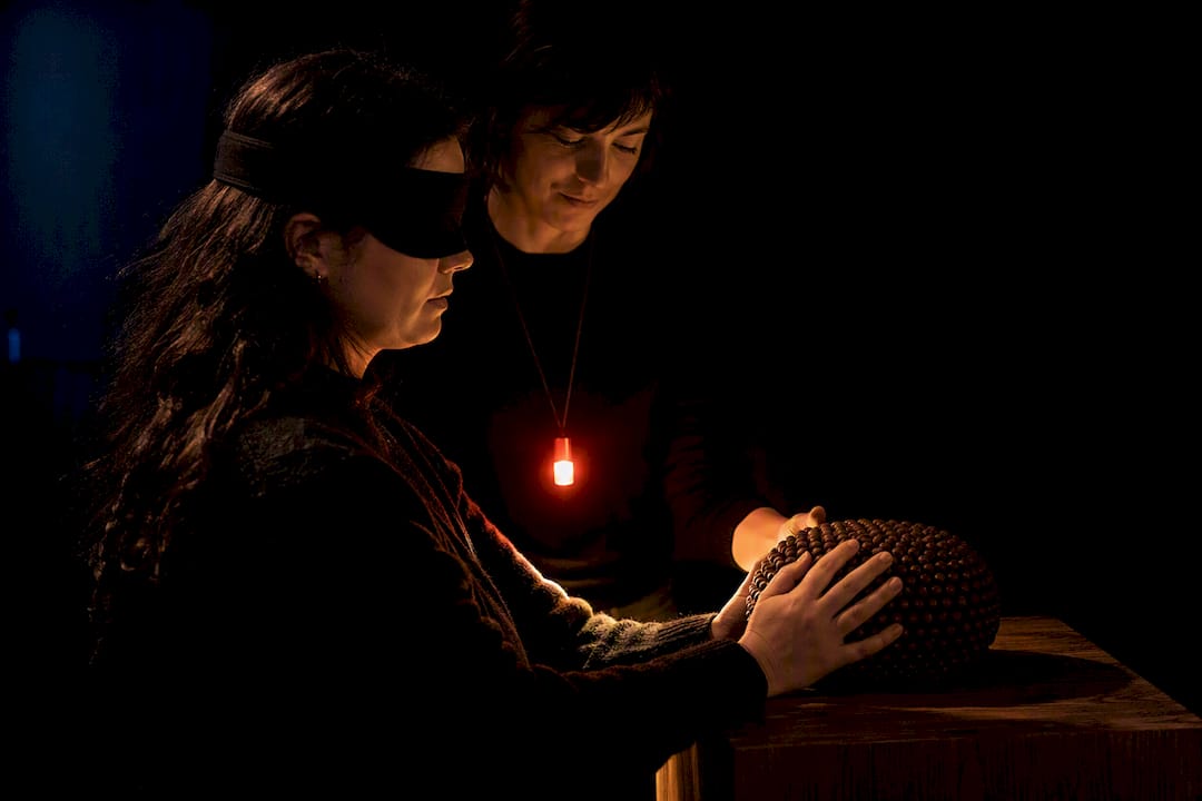 Guide leading participant through darkness
