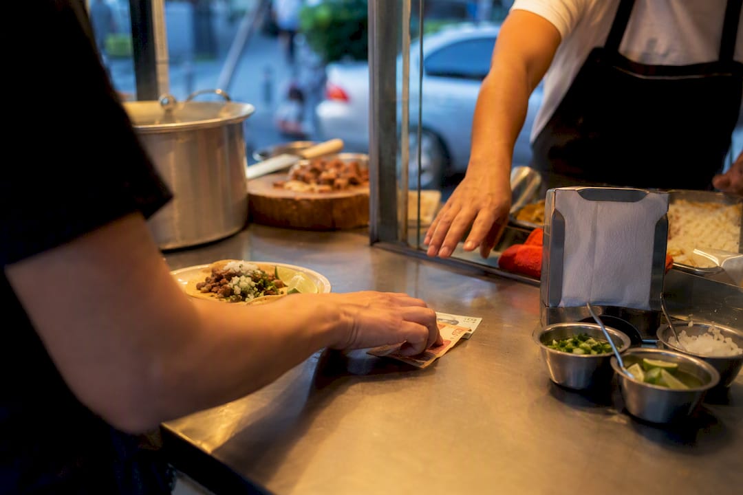 Diner paying after eating street food