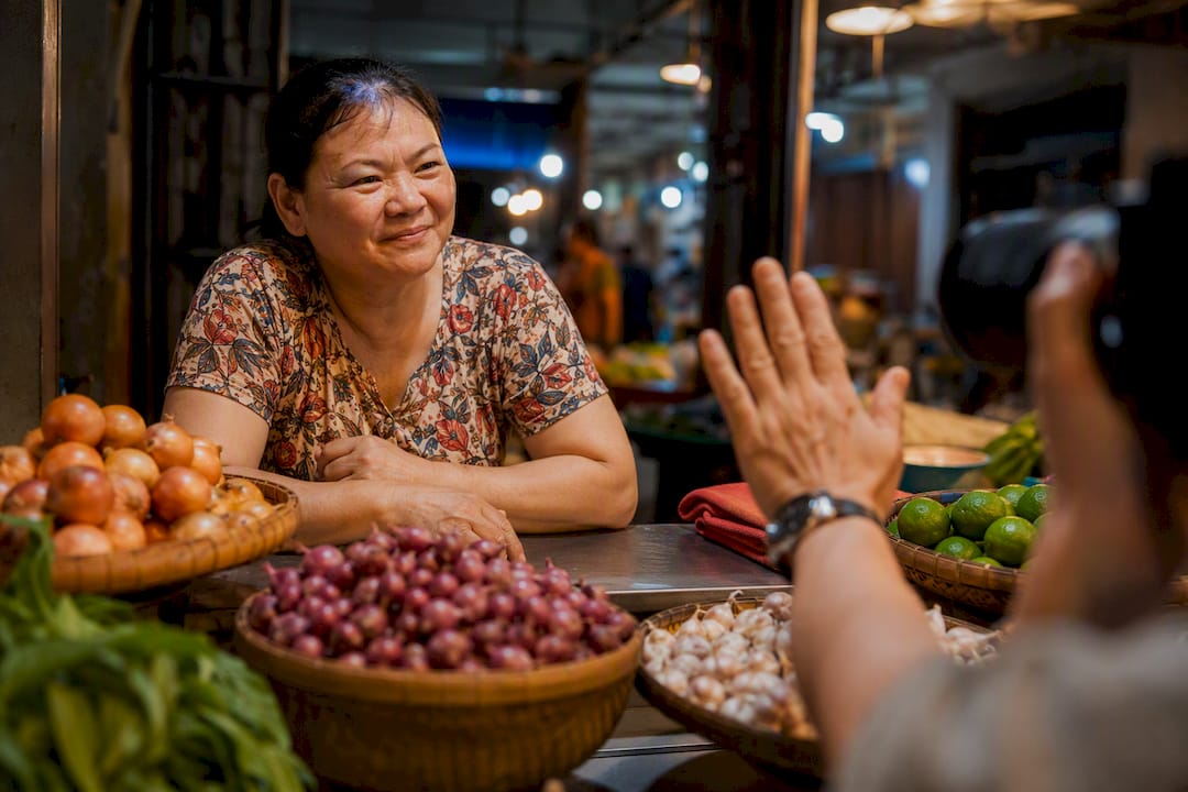 Traveler asking vendor before taking a photo