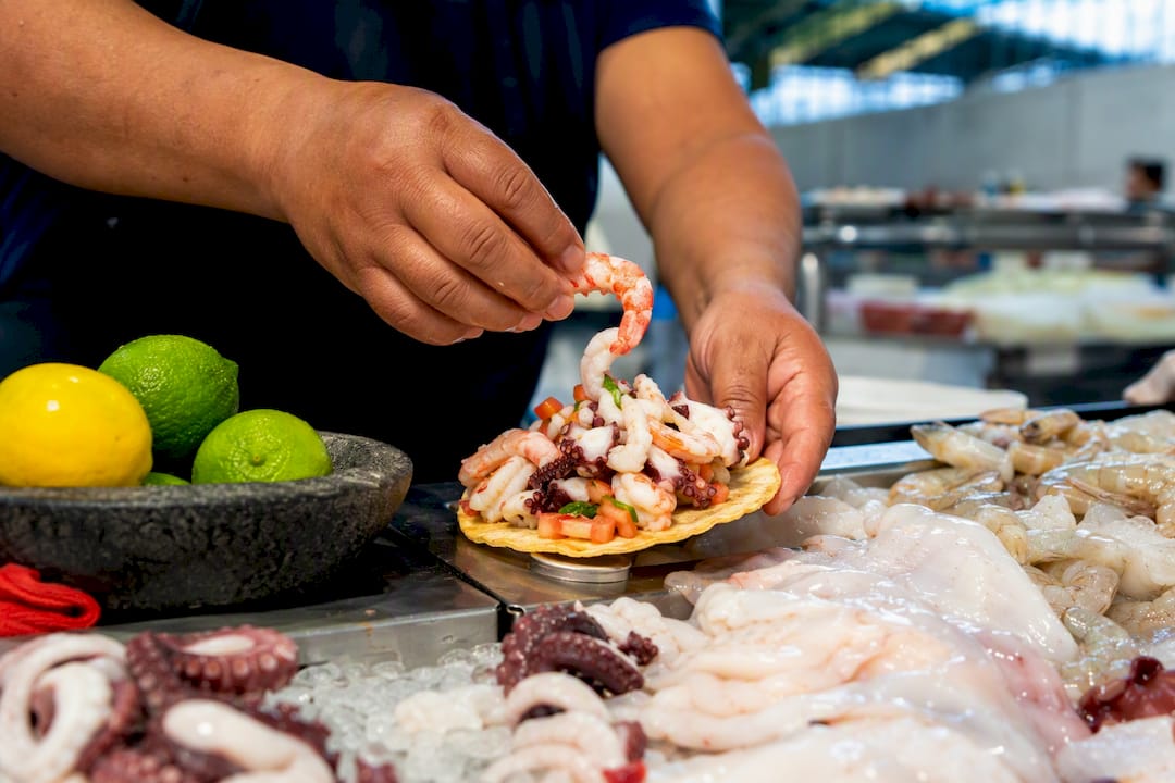 Seafood tostada prepared at Mercado San Juan