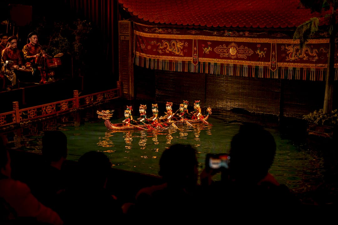 Vietnamese water puppets moving across stage water