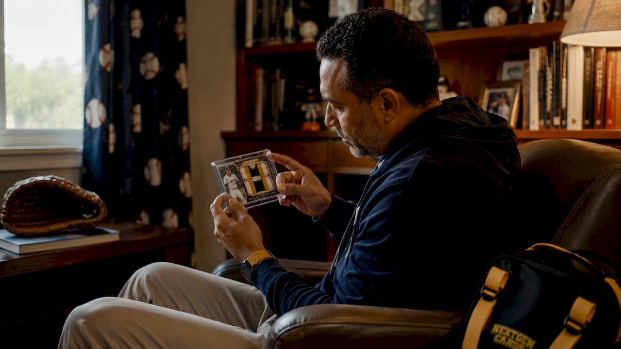 Collector examining MLB debut patch card closely