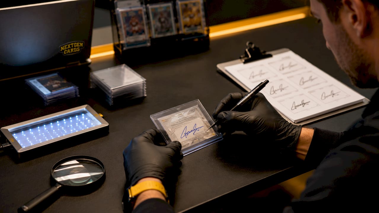 Authenticator examining autograph with tools overhead