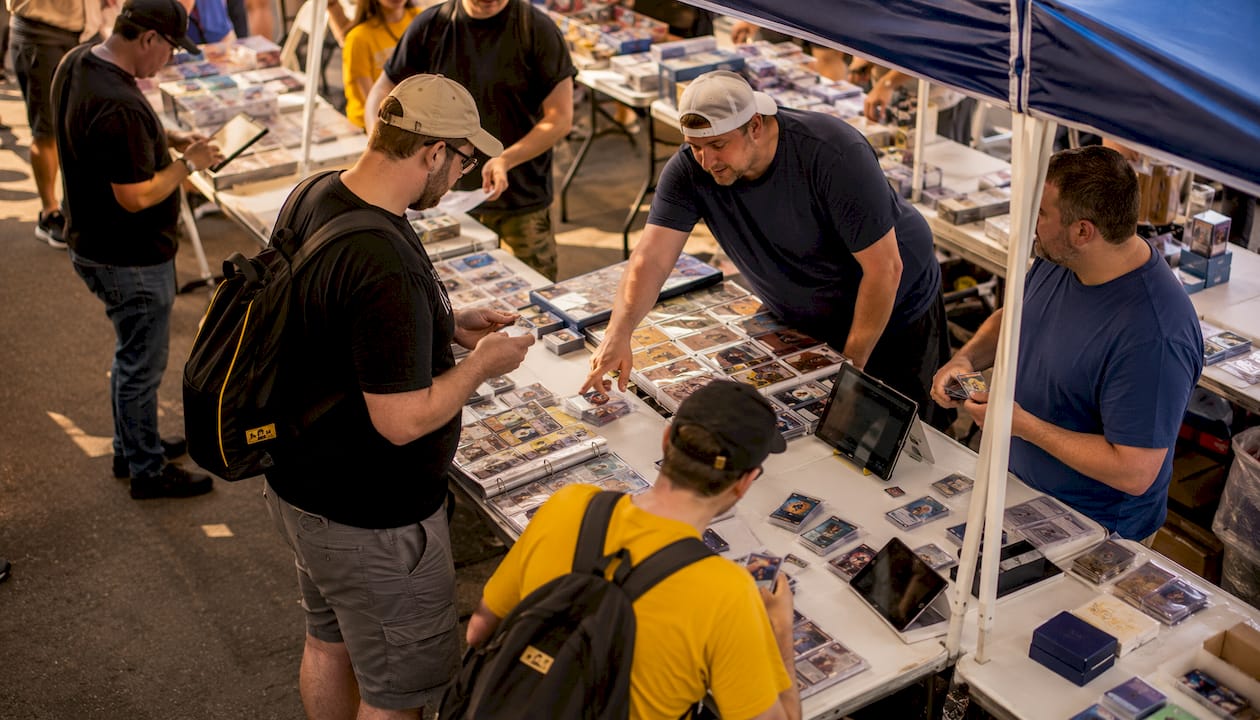 Sports card marketplace setup with digital devices and cards