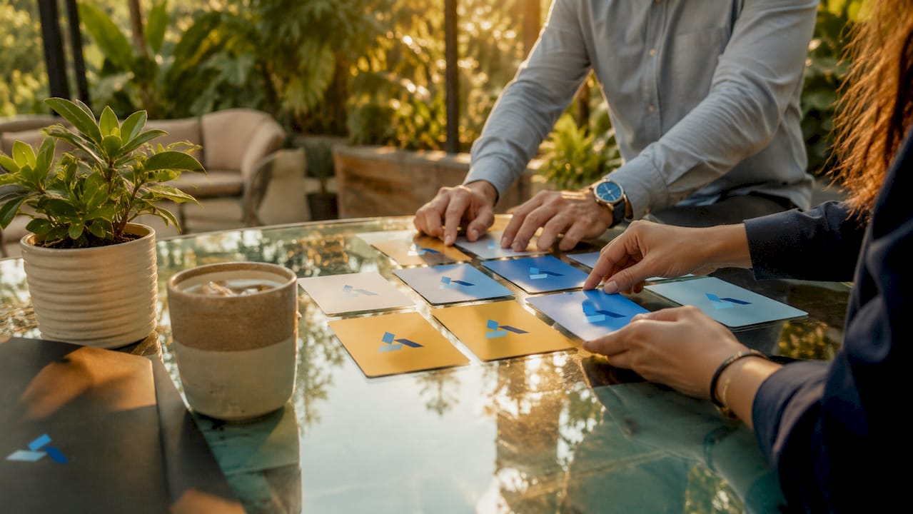 Hands arranging governance cards for automation