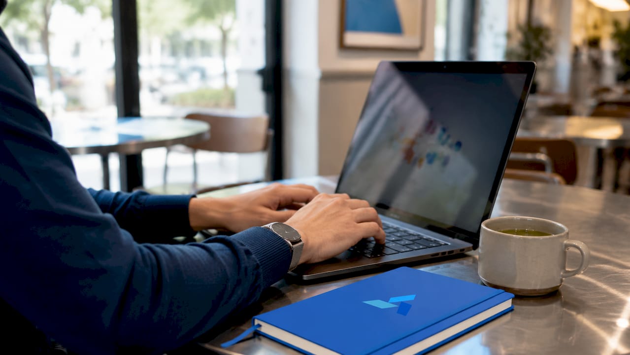 Hands typing on laptop analyzing data sets