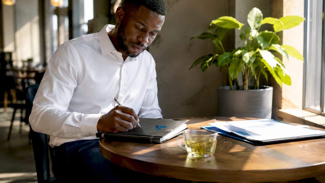 Hands taking notes during customer interview