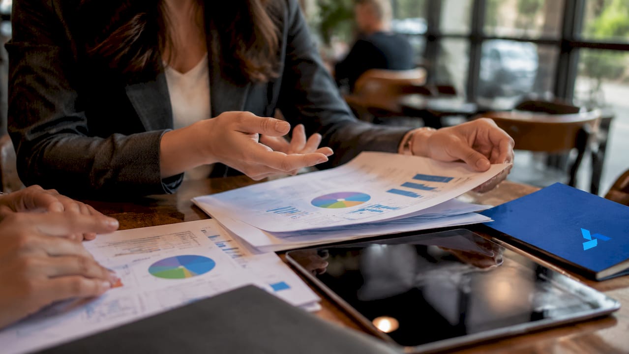 Hands over reports monitoring industry signals with Blue Prysm logo