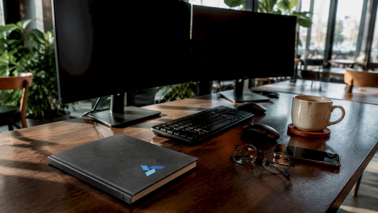 Home office with analytics devices and Blue Prysm logo