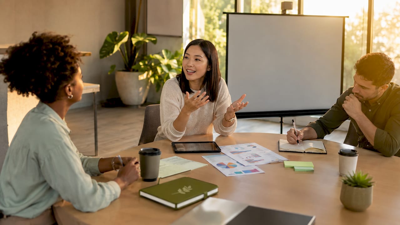 Team discussing workplace stress at meeting table