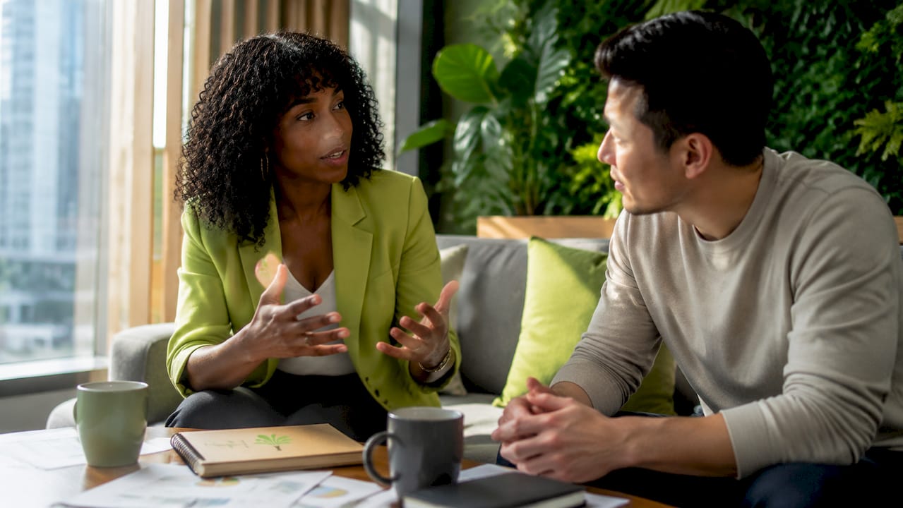 Colleagues discussing communication challenges in office