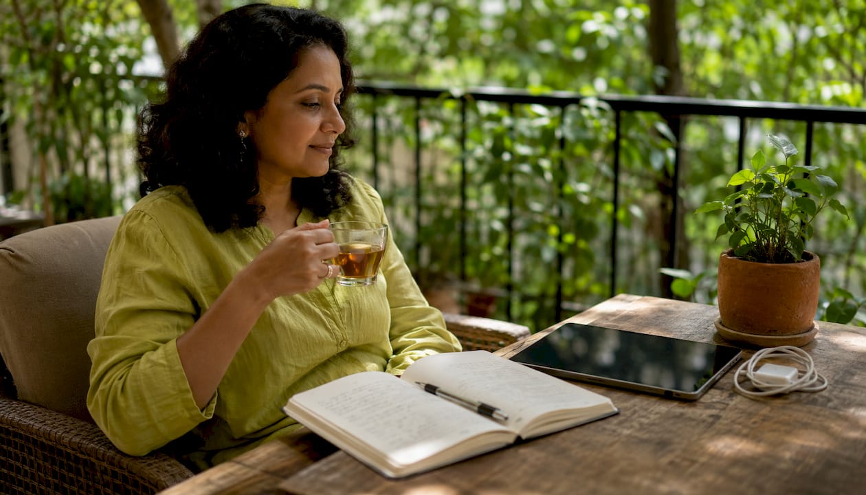 Woman thoughtfully using digital tablet at home