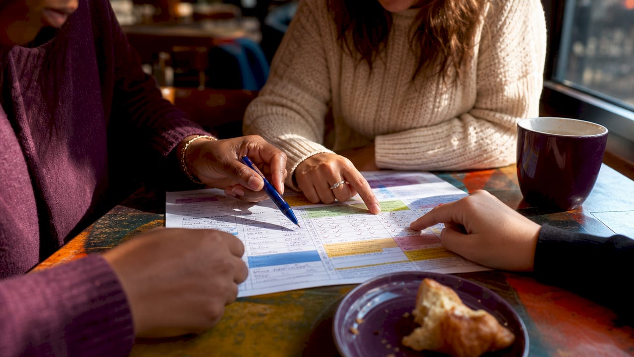 Hands filling federal contract qualification score sheet