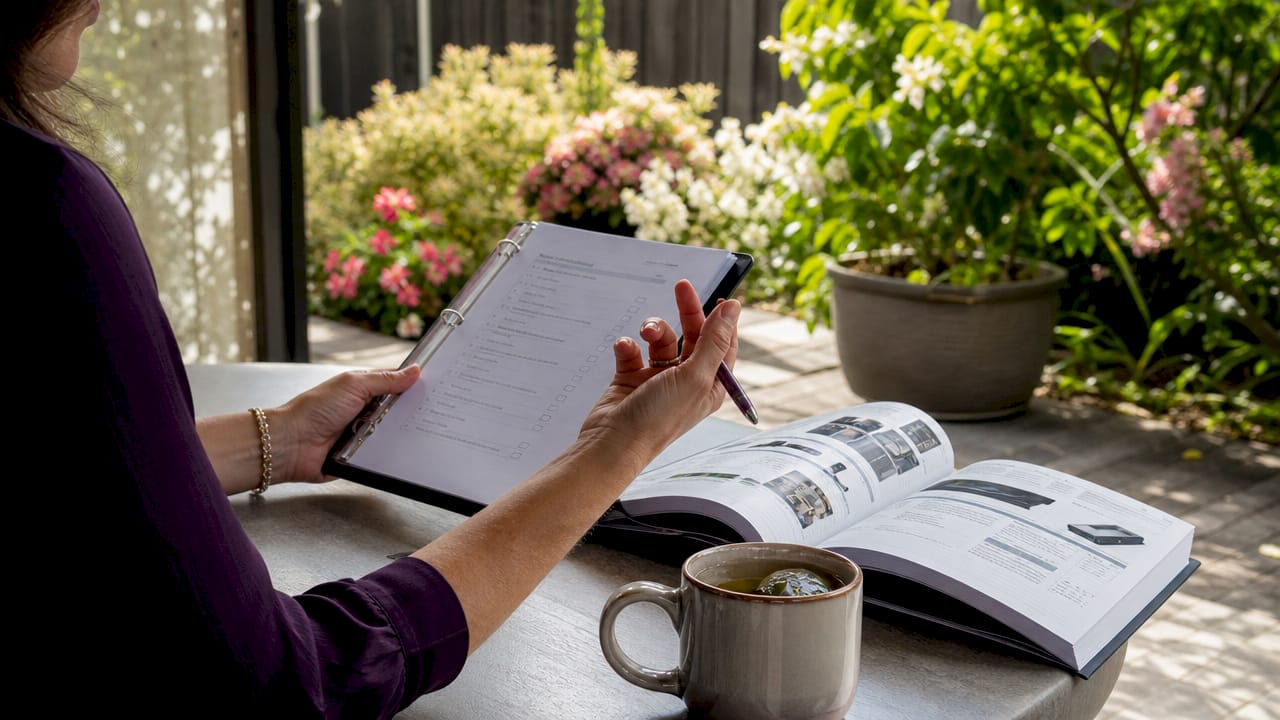 Hands pointing at checklist for vendor onboarding