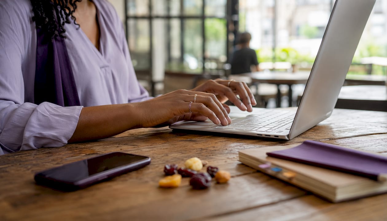 Hands typing near government budget reports