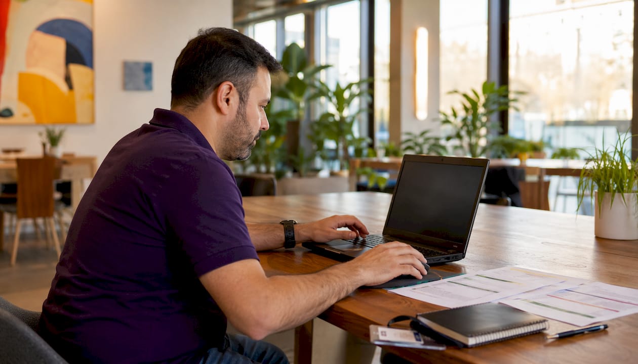 Hands installing GSA SIP software on laptop