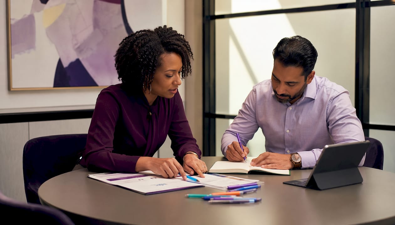 Two professionals discussing MAS IT contract strategy
