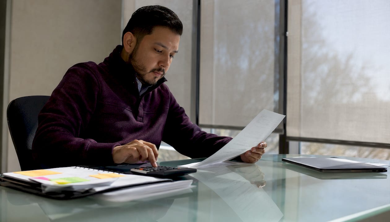 Procurement officer calculating fixed-price contract costs