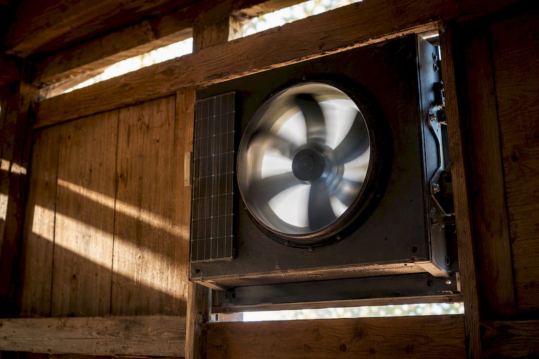 Close-up of solar barn fan with protective casing