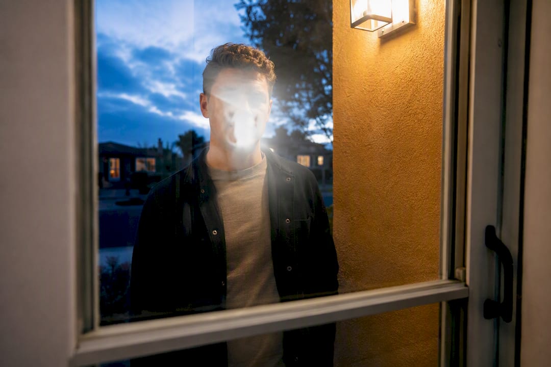 Storm door glare obscuring visitor face