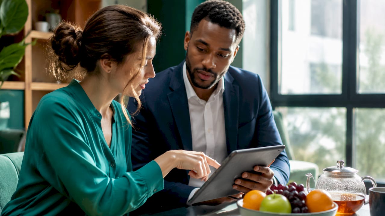 Business colleagues discussing growth with tablet