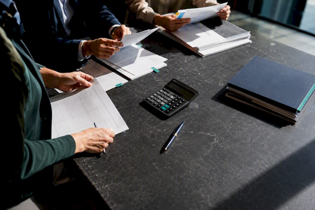 Finance team reviewing certification costs