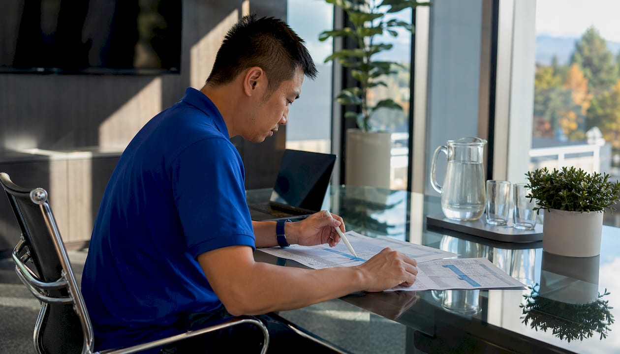 Hands comparing exterior cleaning contract bids