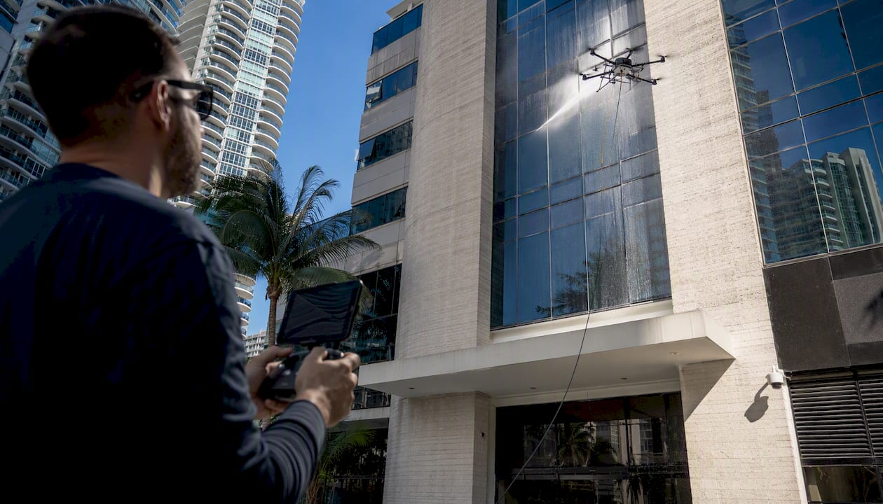 Tethered drone cleaning building facade