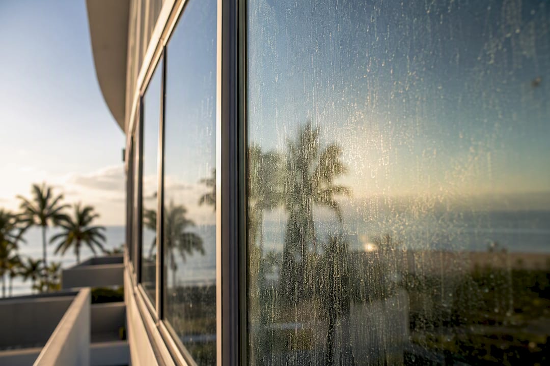 Salt residue visible on hotel curtain-wall glass