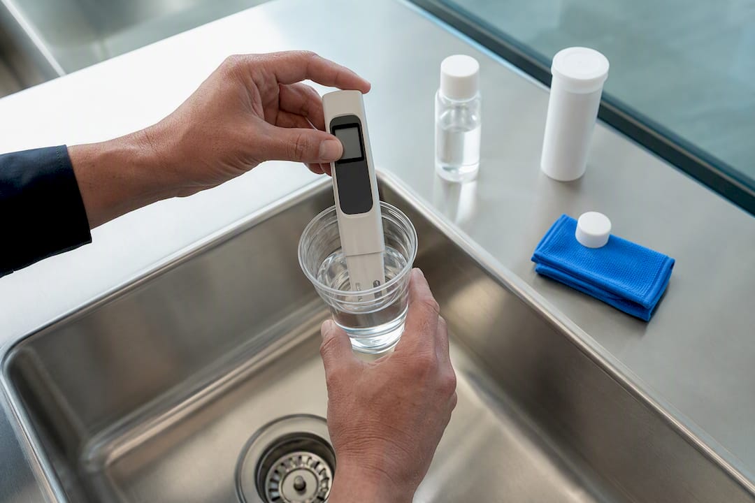 Technician testing water with TDS meter