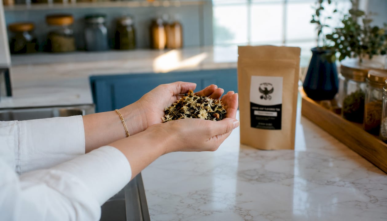 Hands holding different types of tea leaves