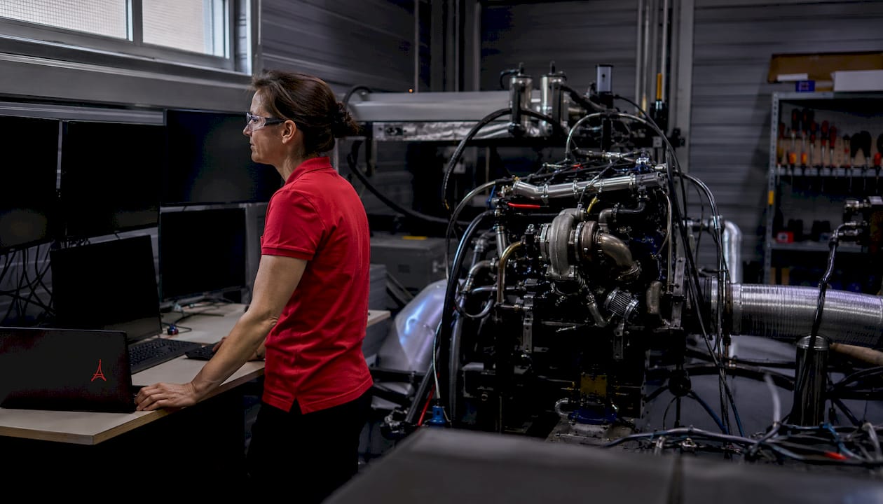 Un ingénieur supervise le fonctionnement d’un banc d’essai pour moteur turbo afin d’analyser ses performances.